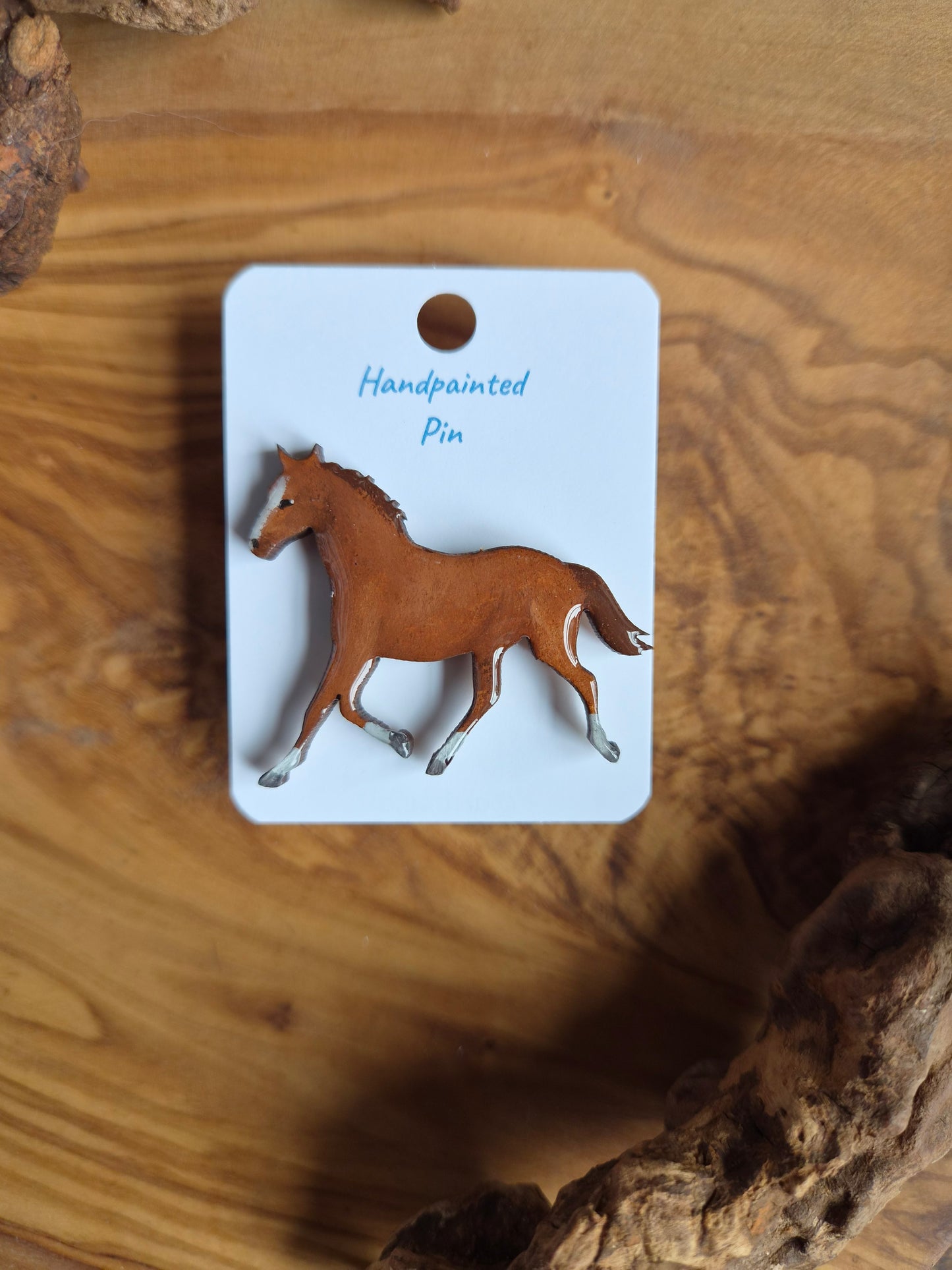 Hand-painted horse shaped wooden pin badge.  Chestnut colour with white socks and blaze
