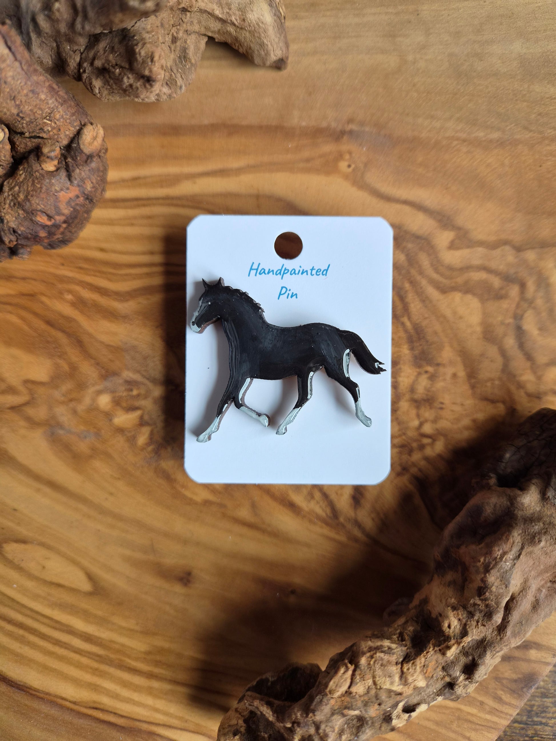 Hand-painted horse shaped wooden pin badge.  Black with white socks and blaze colour