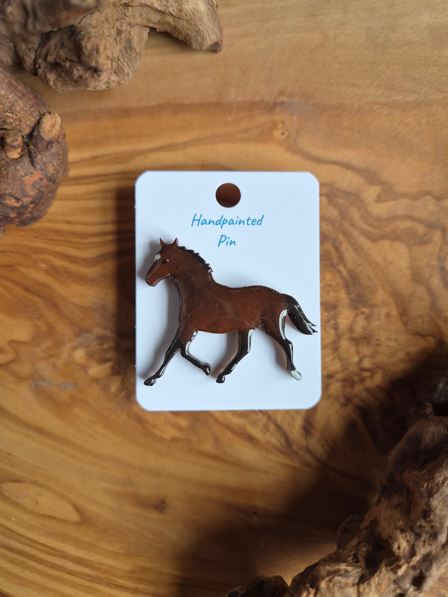 Hand-painted horse shaped wooden pin badge.  Dark bay colour with 1 white sock and star