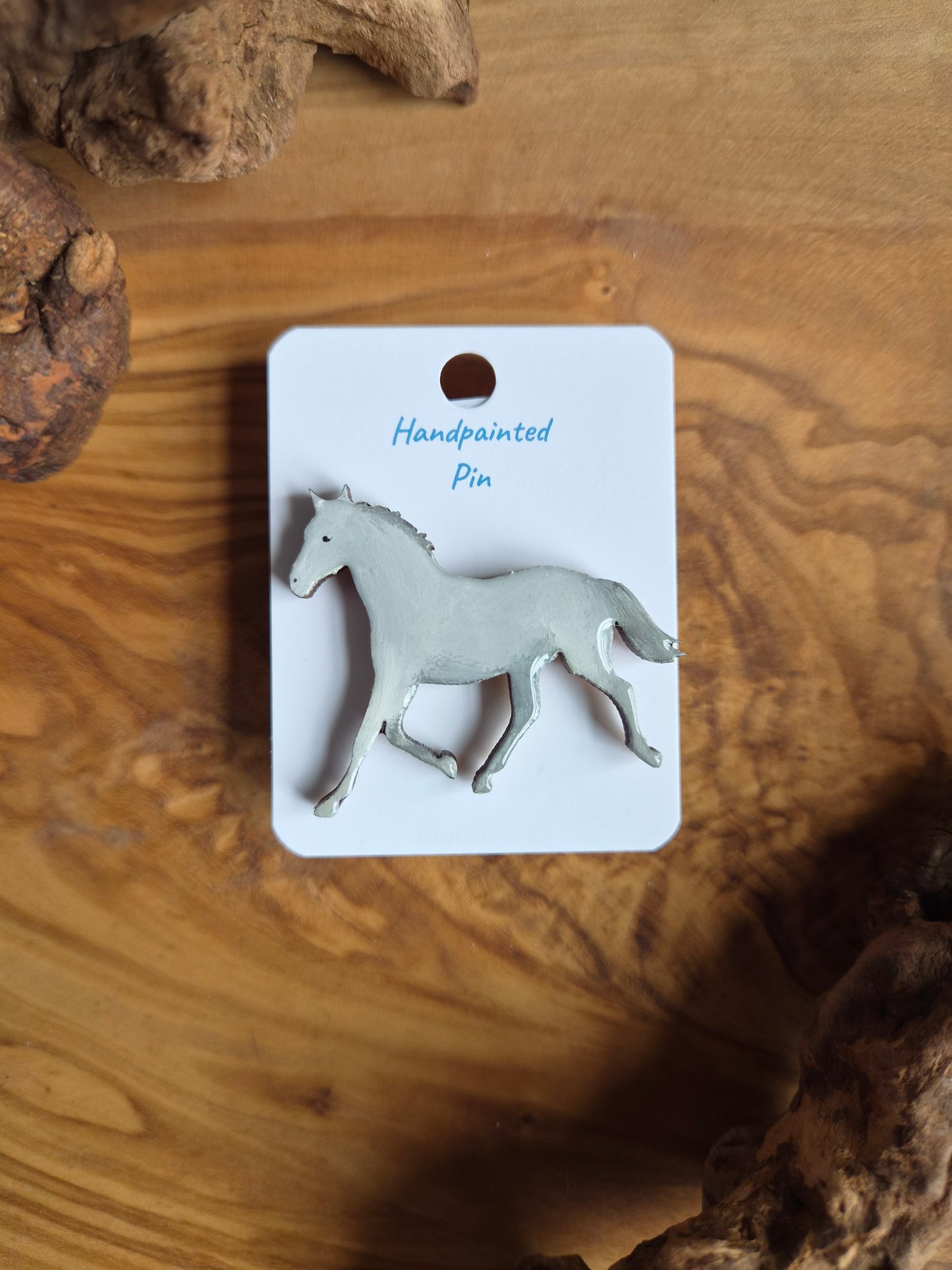 Hand-painted horse shaped wooden pin badge.  grey white colour