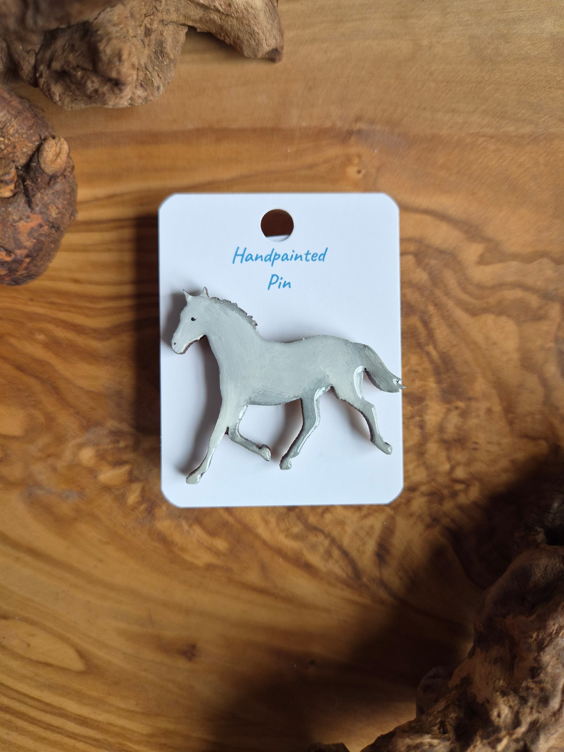 Hand-painted horse shaped wooden pin badge.  grey white colour