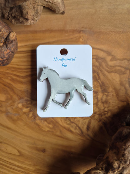 Hand-painted horse shaped wooden pin badge.  grey white colour