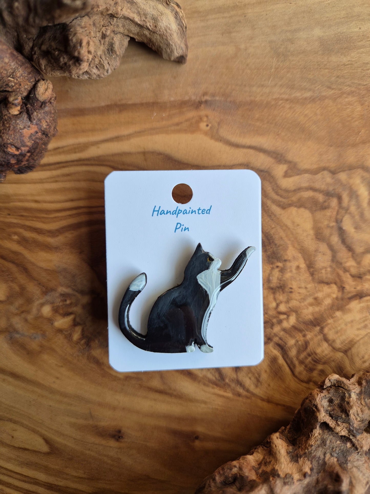 Hand-painted wooden pin badge of a black and white tuxedo coloured cat