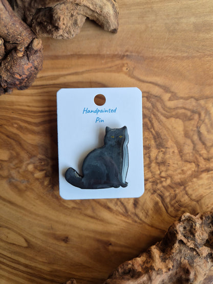 Hand-painted wooden pin badge of a dark grey coloured cat