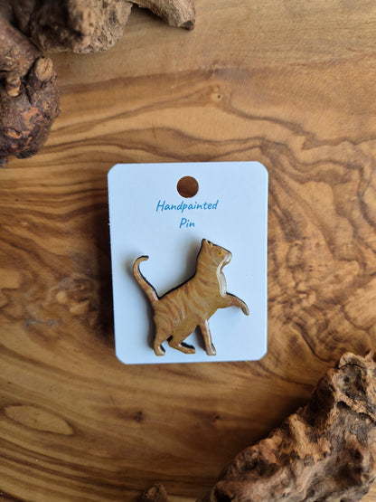 Hand-painted wooden pin badge of a solid ginger cat