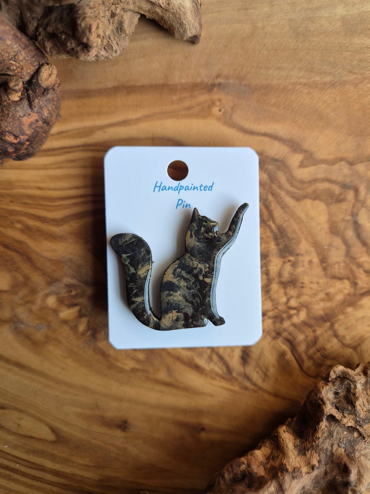 Hand-painted wooden pin badge of a tortoiseshell coloured cat