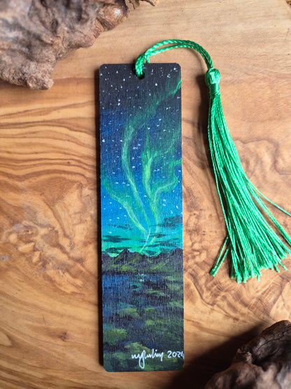 Hand-painted wooden bookmark of the northern lights over the mountains
