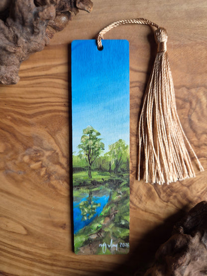 Hand-painted wooden bookmark of the Mosset Pond and reflections of trees in the pond, beside the Mosset Tavern in Forres
