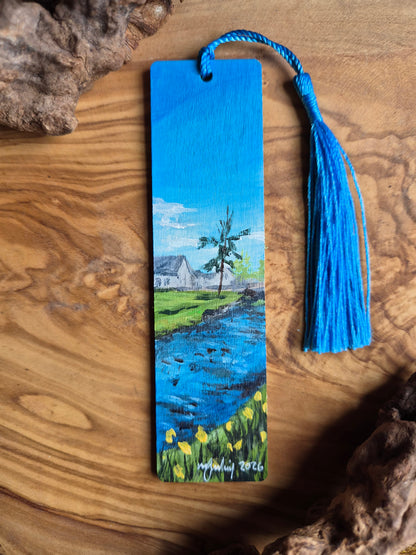 Hand-painted wooden bookmark of the burn near the war memorial in Forres with bright Yellow daffodils in the foreground