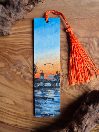 Hand-painted wooden bookmark of a sunset behind the lighthouse in Mount Dora, Florida
