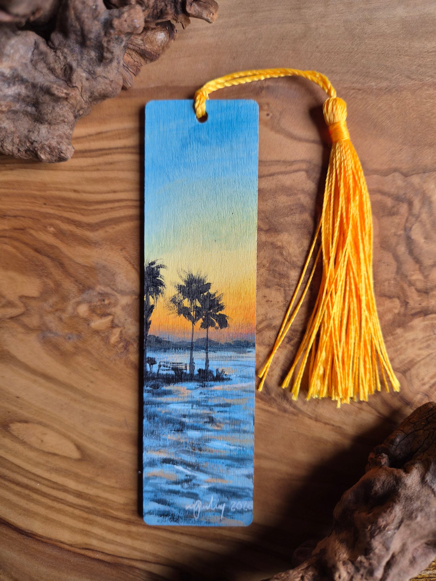 Hand-painted wooden bookmark of a sunset on Lake Dora with palm tree Silhouettes, in Mount Dora Florida
