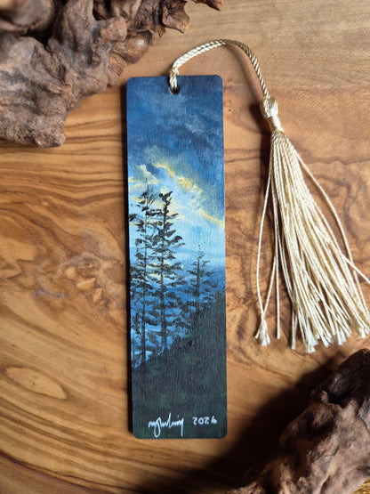 Hand-painted wooden bookmark of tree silhouettes against a evennig sunset