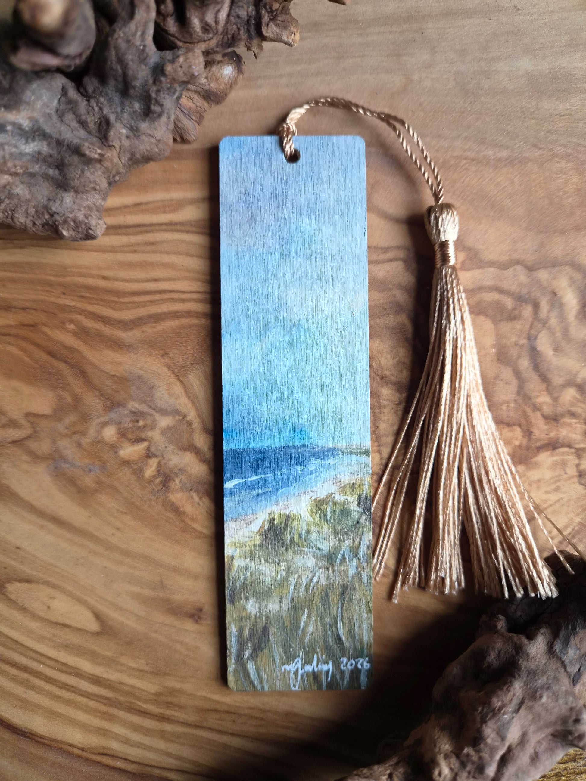 Bookmark with a beach scene painting of Nairn beach with sand dunes and tassel on a wooden surface