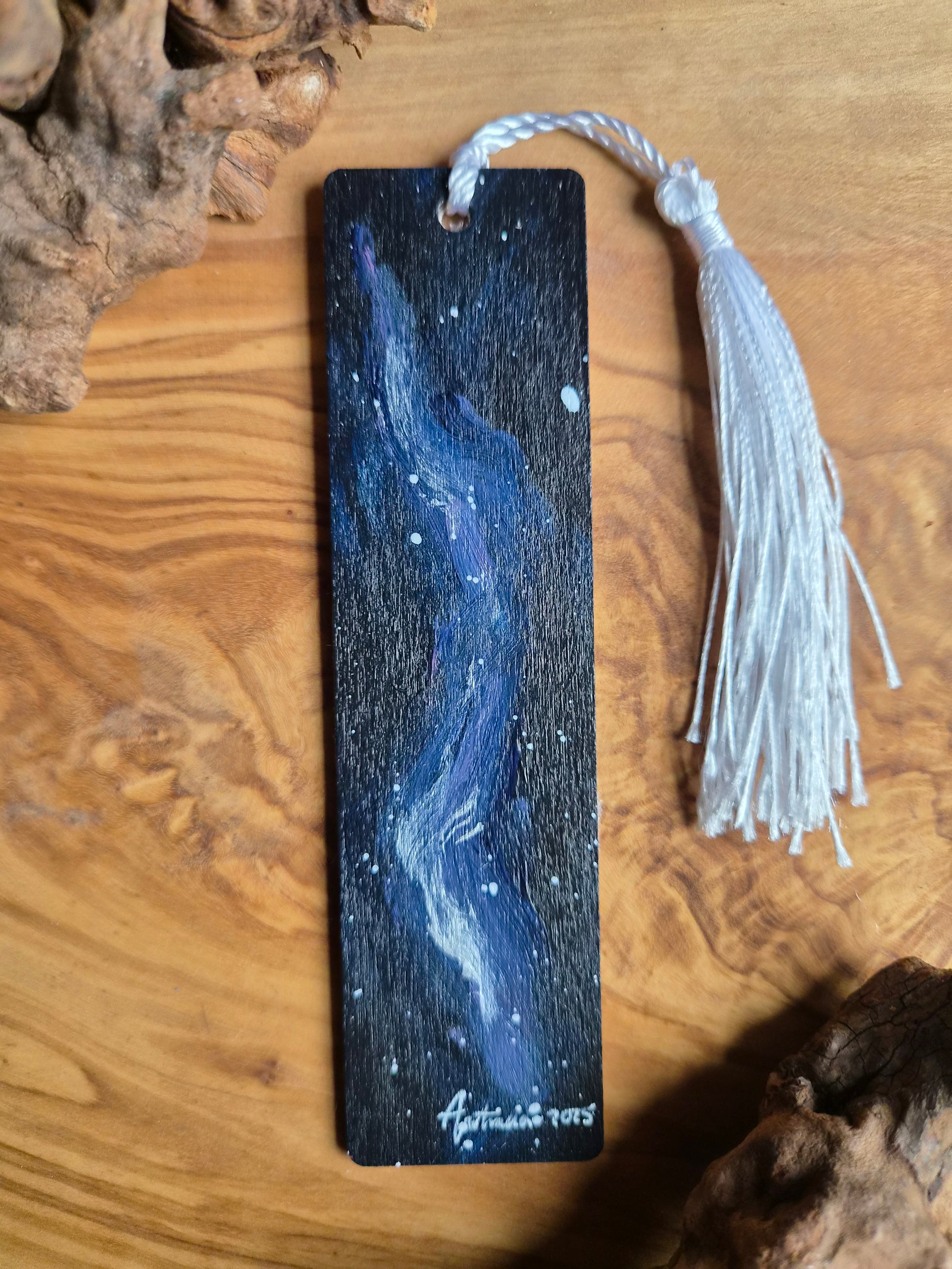 Hand-painted wooden bookmark ofblue and silver galaxy design