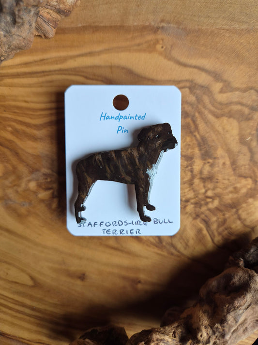 Hand-painted staffordshire bull terrier dog pin badge, painted onto wood. Brindle colour with white chest and paw