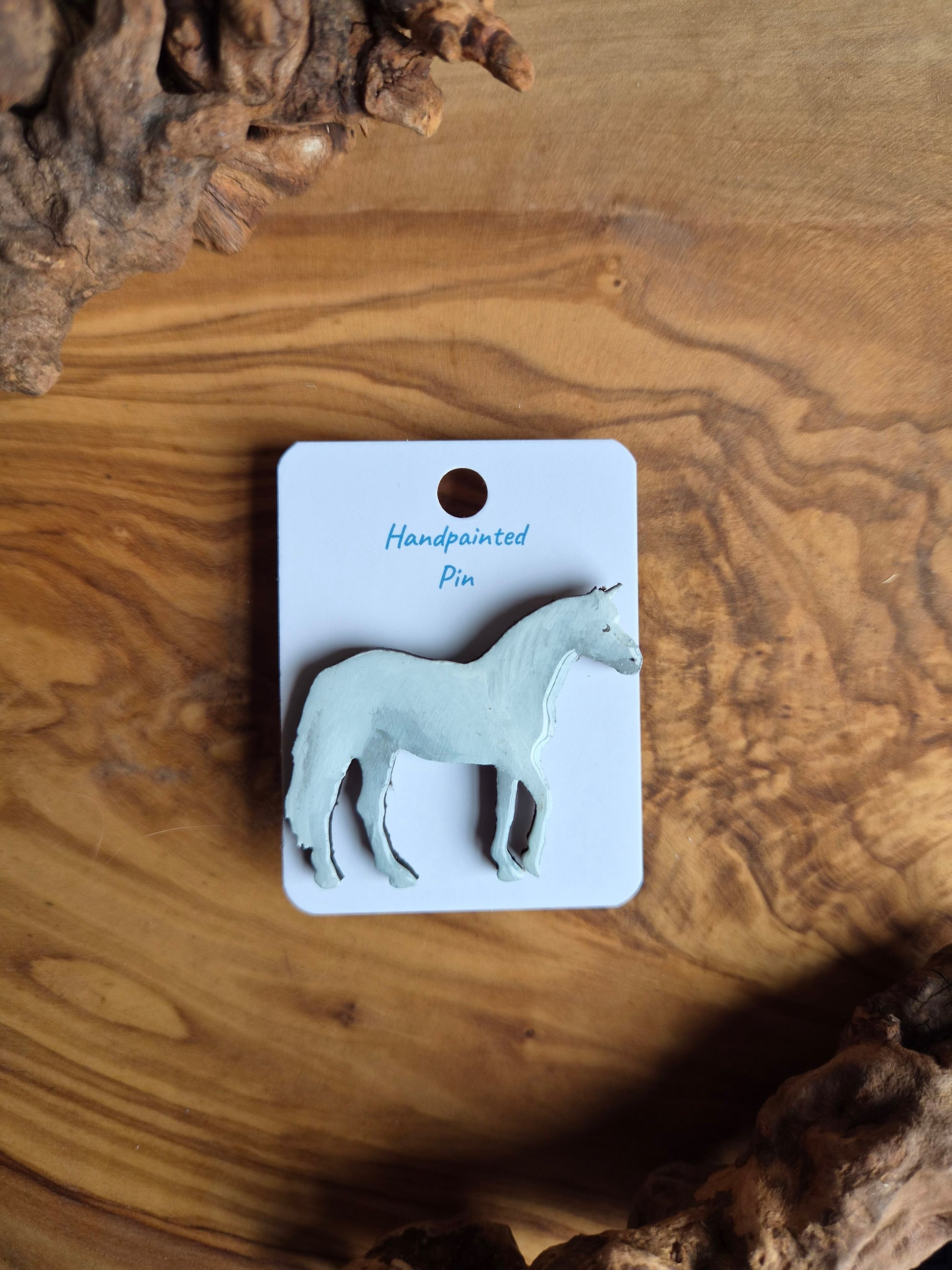 hand-painted white unicorn shaped wooden pin badge