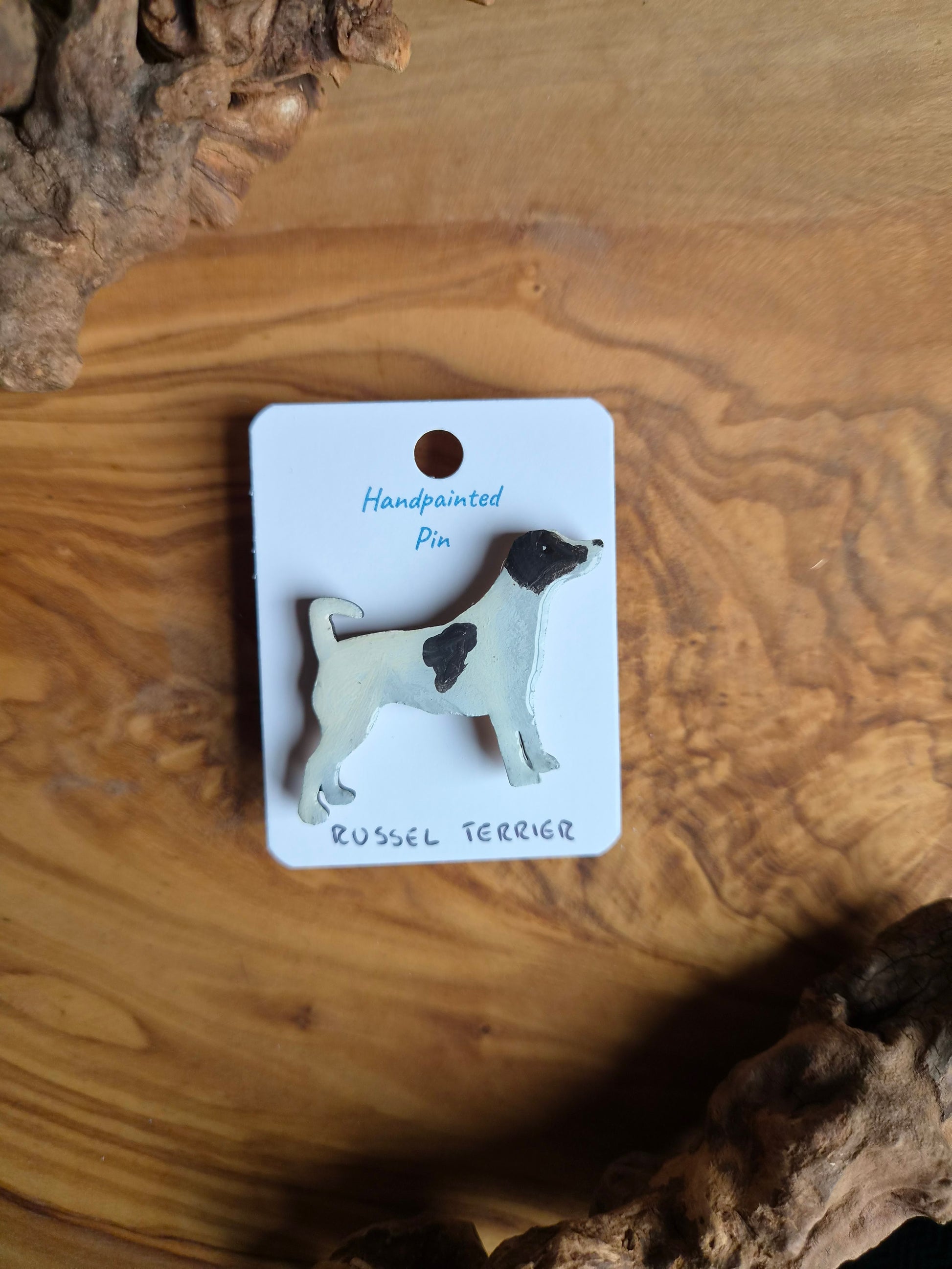 White and black patches, hand-painted wooden pin badge of a Russel Terrier dog