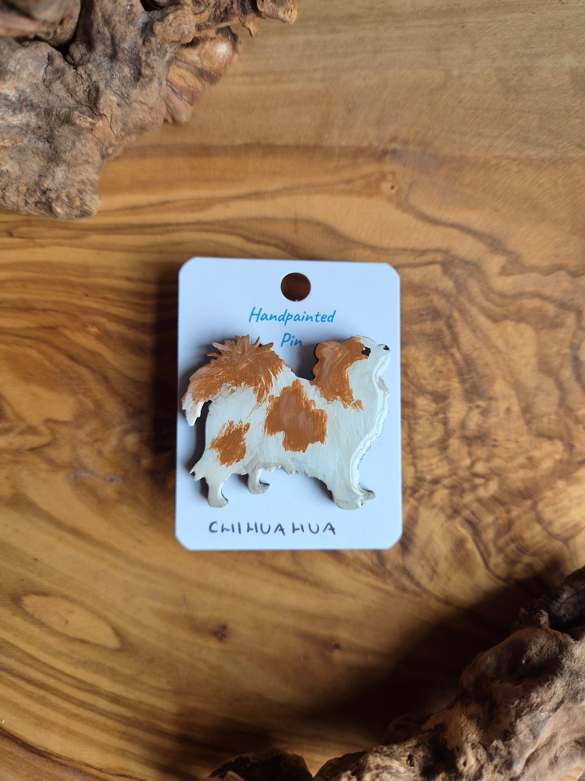 Hand-painted wooden dog pin badge of a longhaired red and white chihuahua