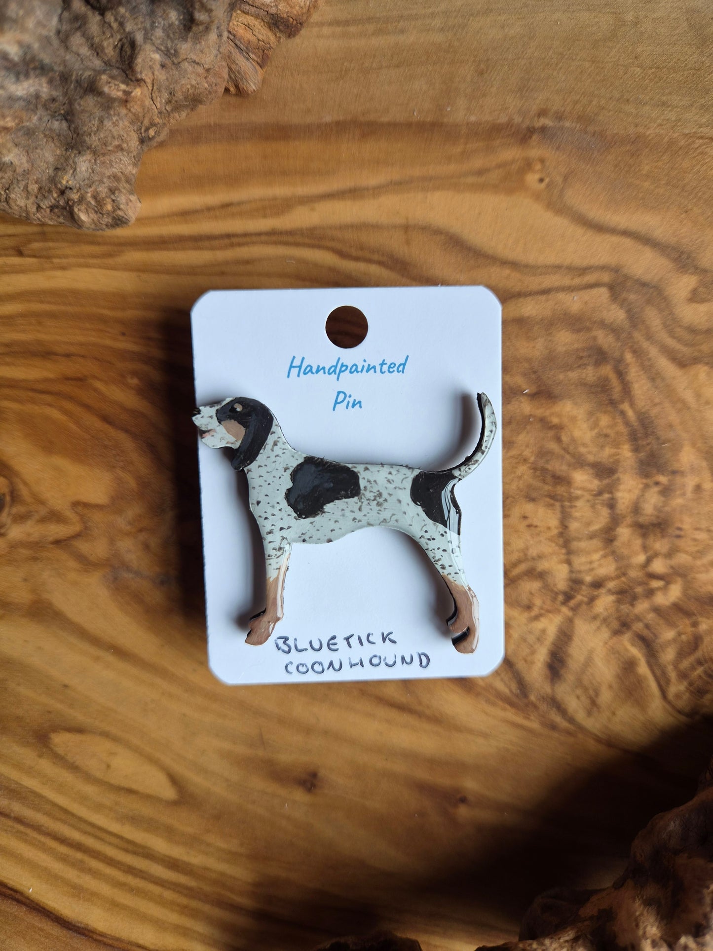 Hand-painted wooden dog shaped pin badge of a bluetick coonhound