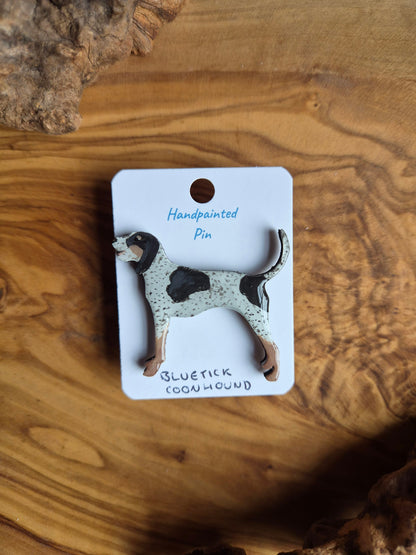 Hand-painted wooden dog shaped pin badge of a bluetick coonhound