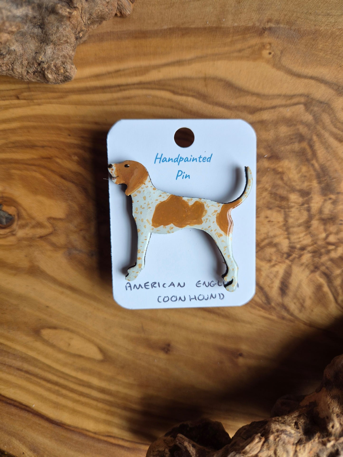 Hand-painted wooden dog shaped pin badge of an American English coonhound