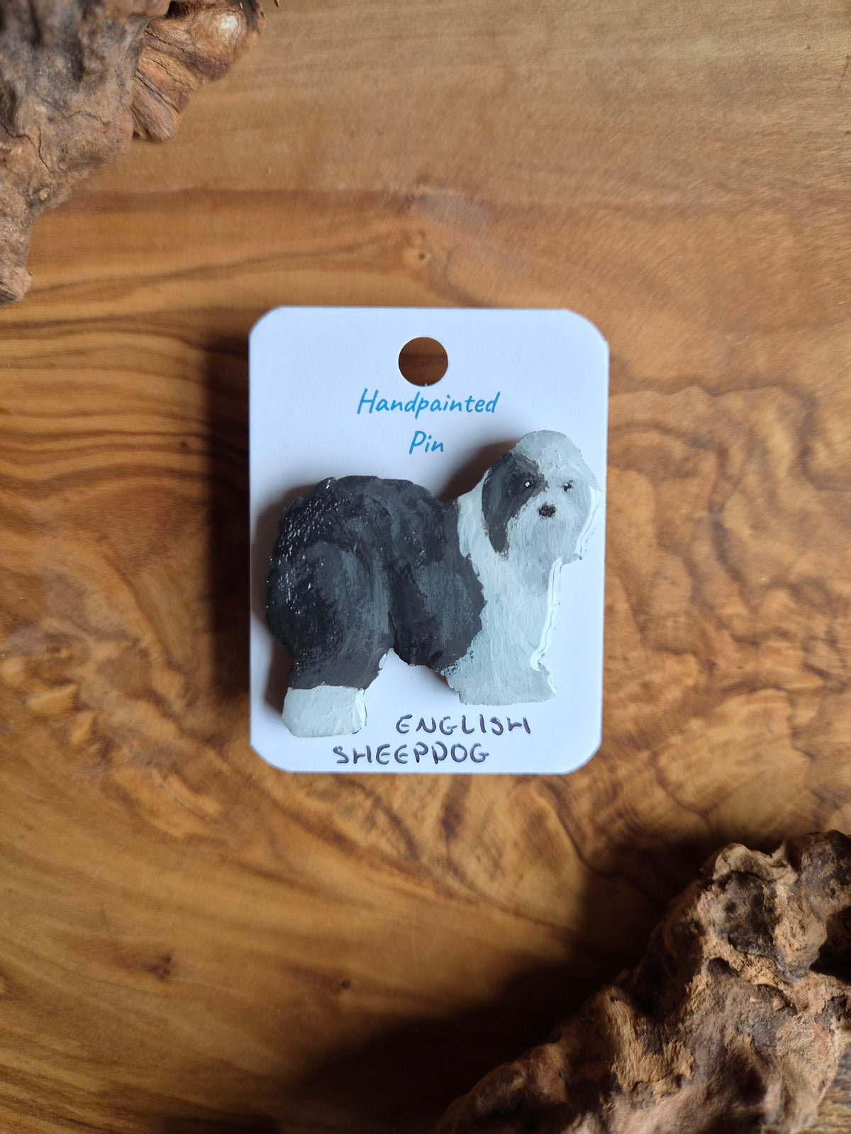 Hand-painted old english sheepdog wooden pin badge with one grey ear patch over the eye