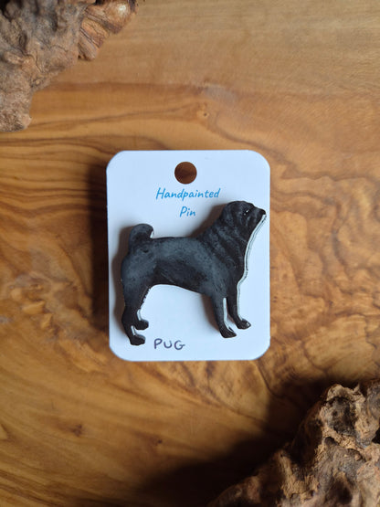 Hand-painted wooden pin badge of a black coloured Pug