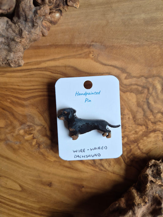 Hand-painted wooden dog shaped pin badge of the wirehaired dachshund, black and tan