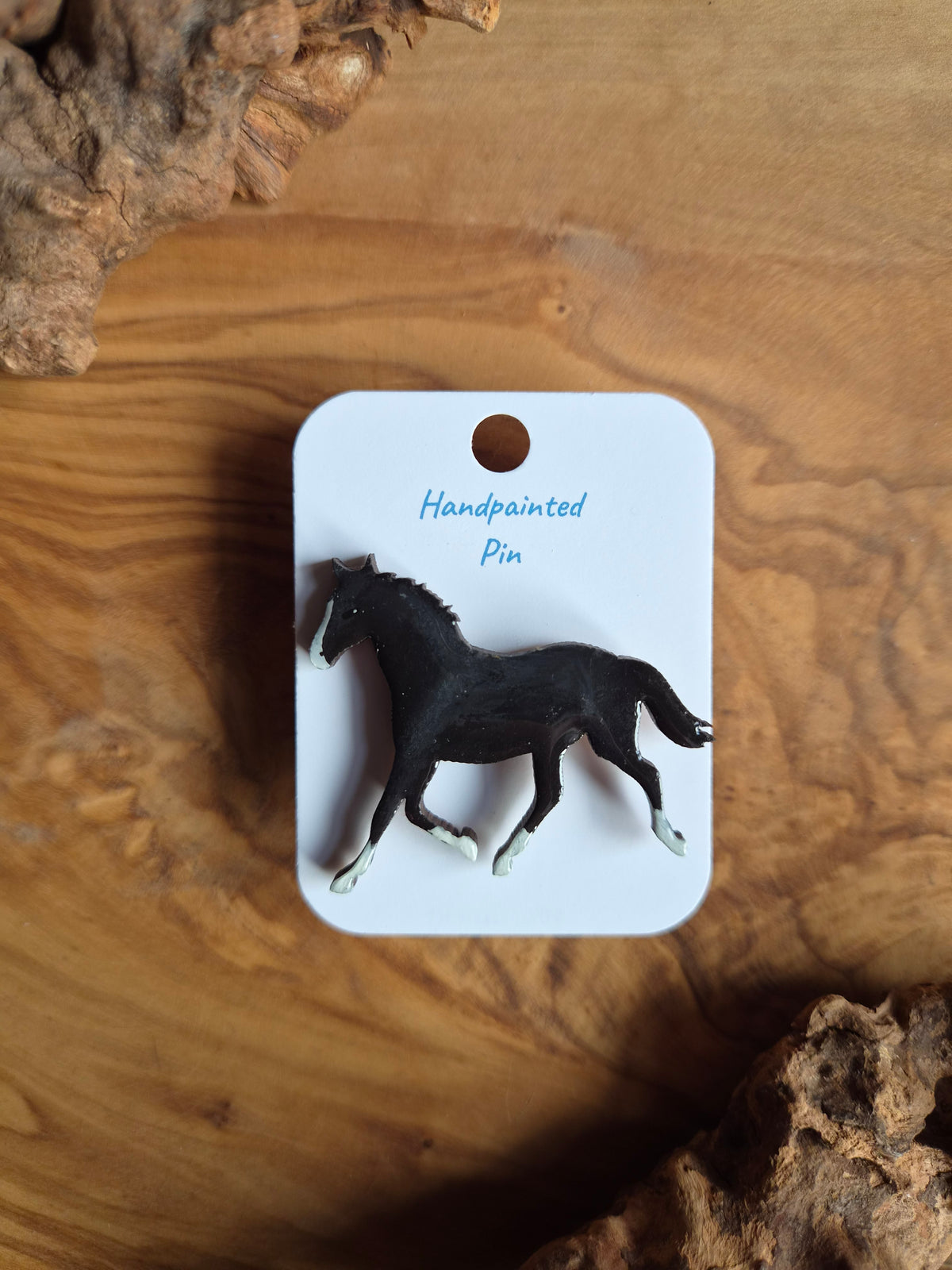 Hand-painted horse shaped wooden pin badge. Black with white blaze and 4 white socks
