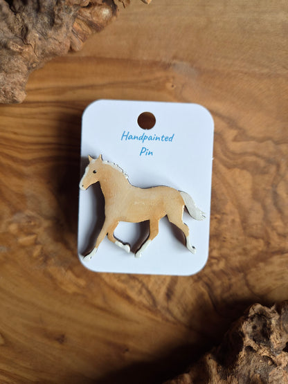 Hand-painted horse shaped wooden pin badge.  light palomino coloured horse with white blaze, socks, mane & tail