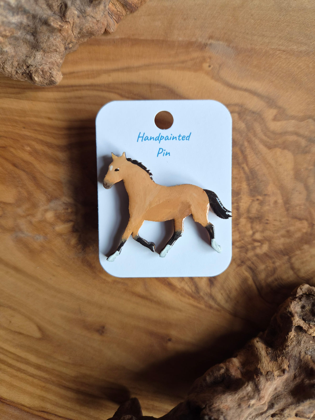 Hand-painted horse shaped wooden pin badge.  Light bay, buckskin, dun coloured horse with a white star and 3 white socks