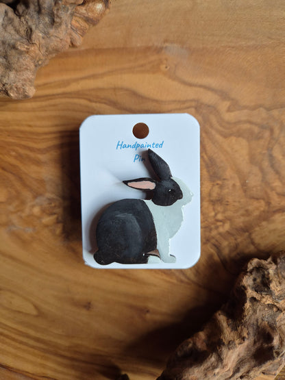 Hand-painted rabbit shaped wooden pin badge.  Black and white patches colour