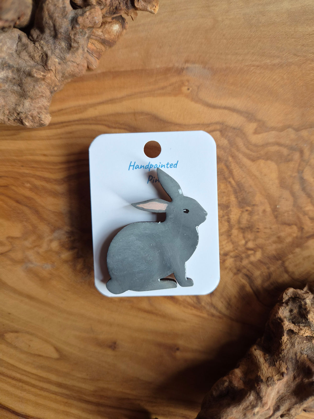 Hand-painted rabbit shaped wooden pin badge.  Light grey colour