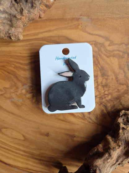 Hand-painted rabbit shaped wooden pin badge.  Dark grey colour